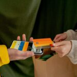 A close-up of a contactless payment using a credit card and smartphone, highlighting modern technology.